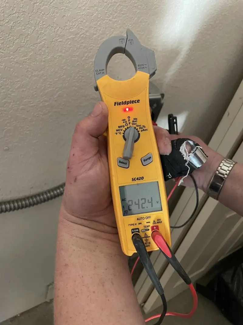 Voltage testing with clamp meter during Ceiling Fan Installation in Old Tappan